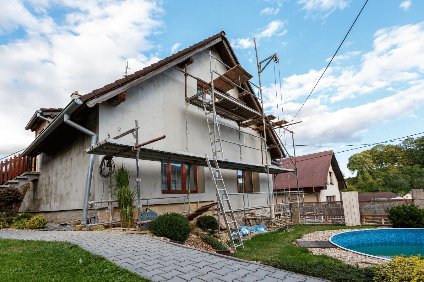 A house is being painted with scaffolding around it.