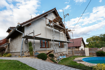 A house is being painted with scaffolding around it.