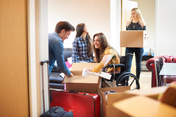 A group of people are moving into a new house.