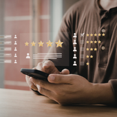 Person holding a smartphone with star ratings and review icons overlaid on screen