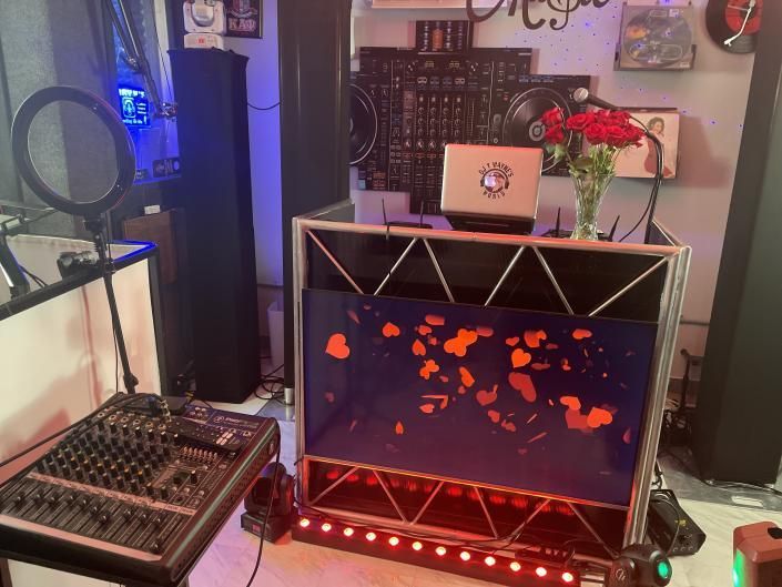 Home workspace with laptop, mixer, and glowing fish tank display in a cozy room