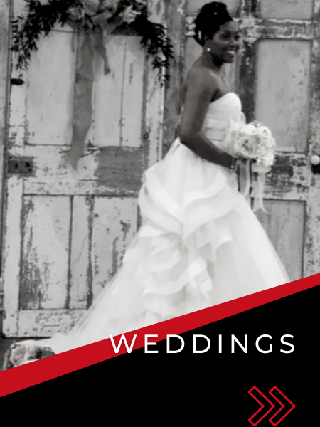 Bride in white wedding gown holding bouquet before rustic doors, with “WEDDINGS” text overlay