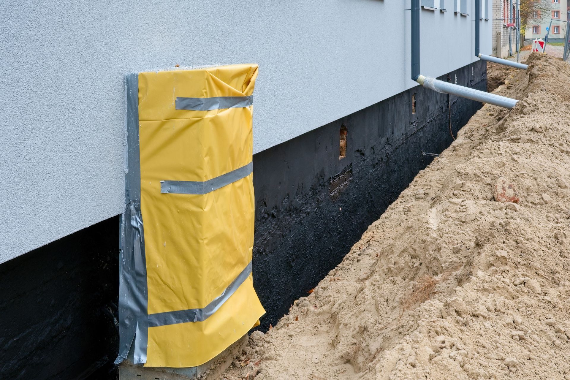 Foundation waterproofing repair with exposed wall and seal barrier.