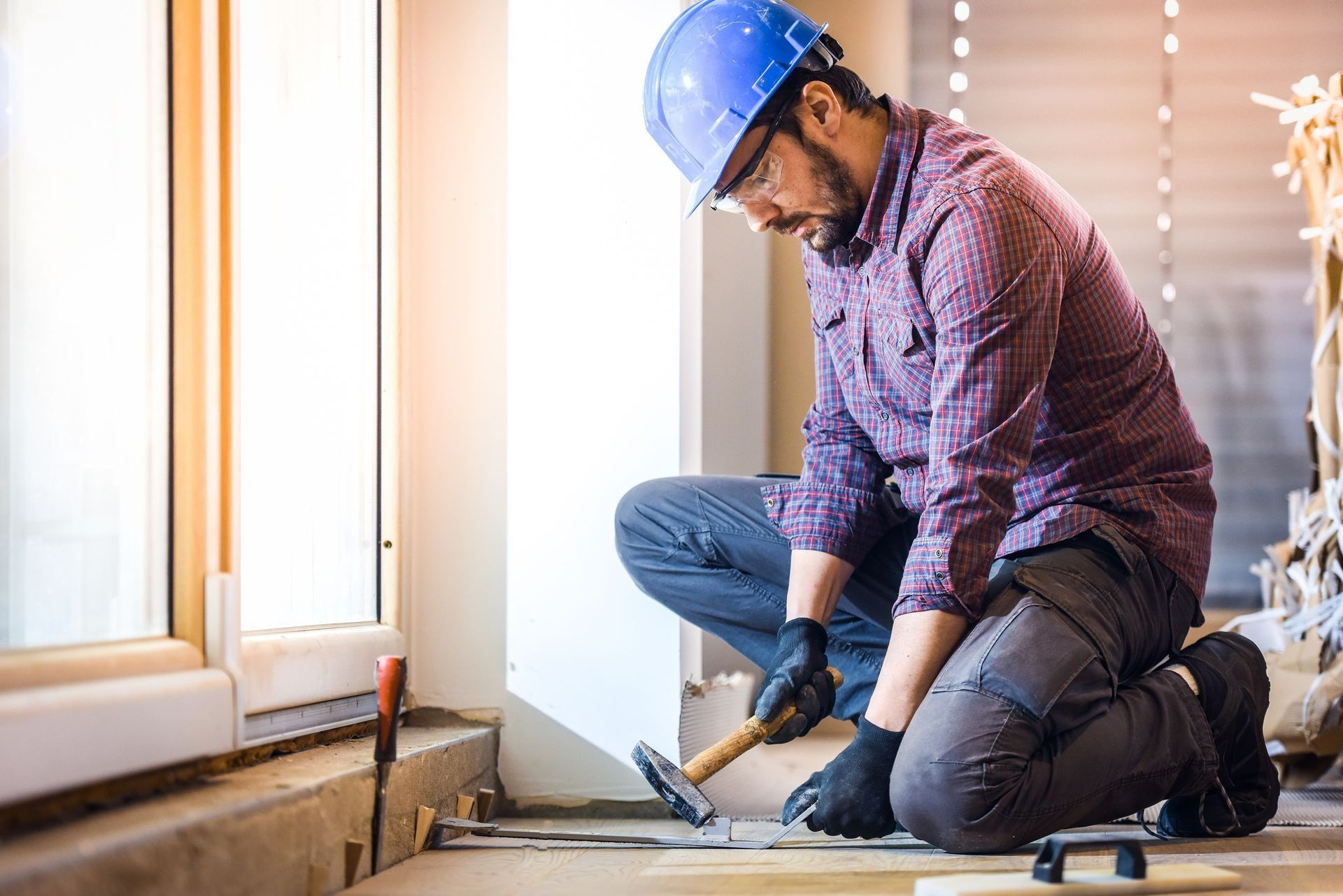 Worker repairing subfloor as part of a home foundation repair project. Worker repairing subfloor as part of a home foundation repair project.