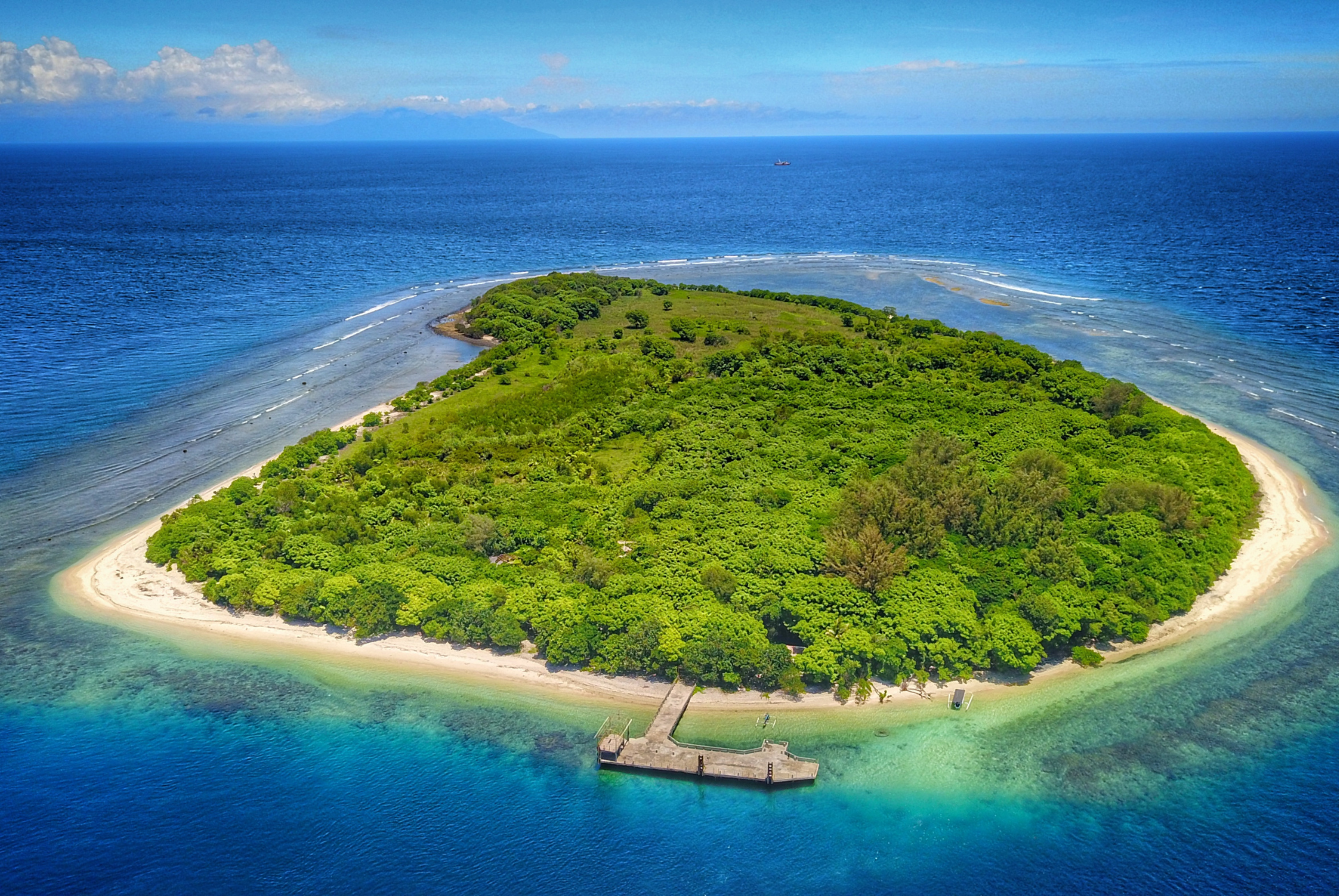 An aerial view of a small island in the middle of the ocean.