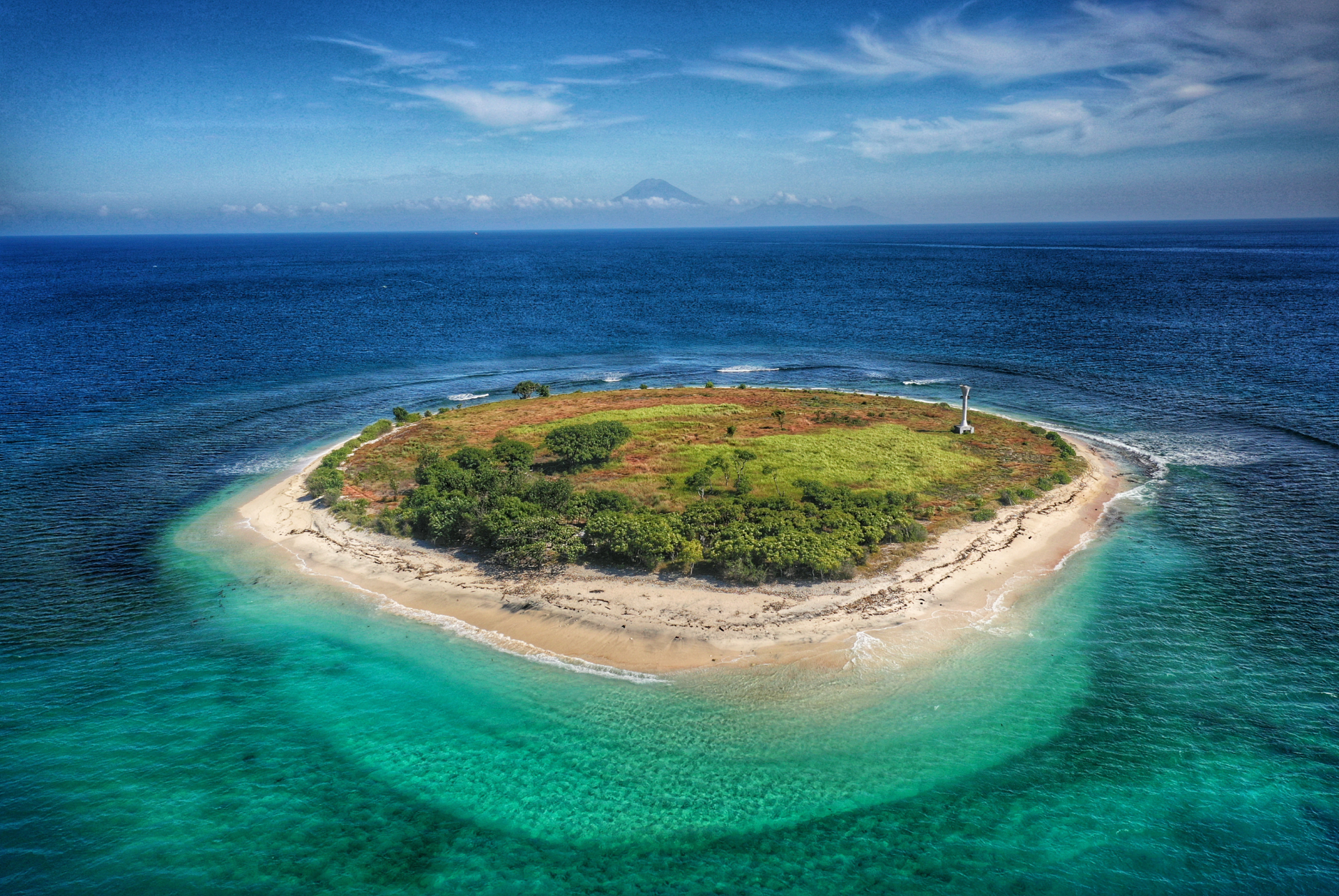 An aerial view of a small island in the middle of the ocean.