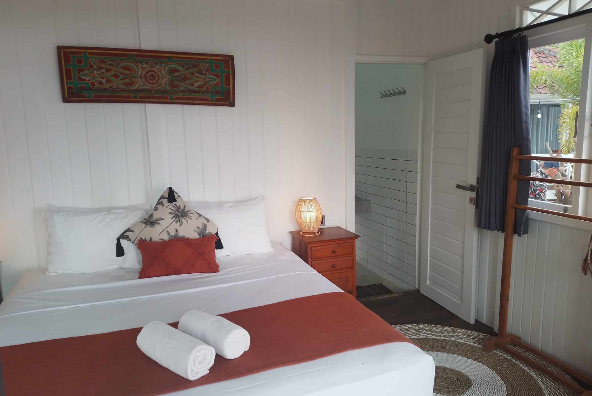 A bedroom with a bed , nightstand , and window.
