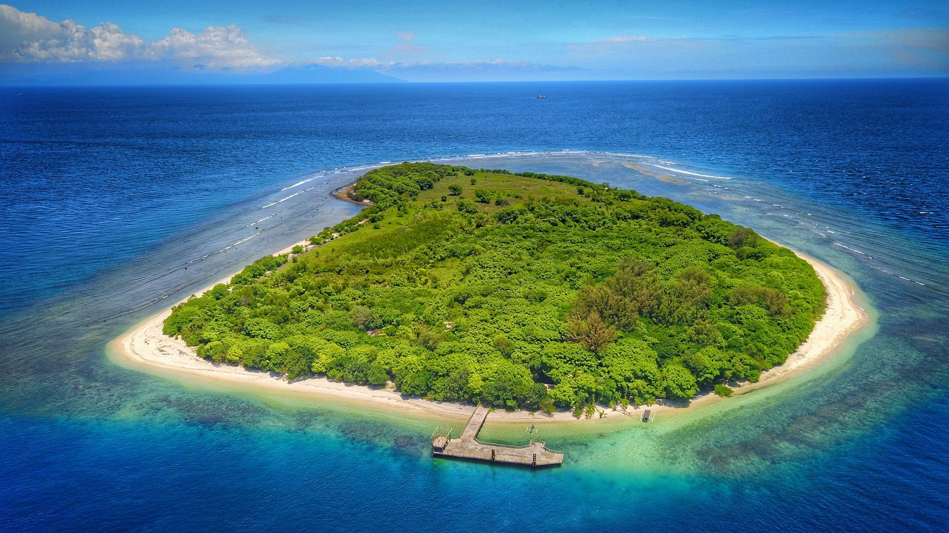 An aerial view of a small island in the middle of the ocean.