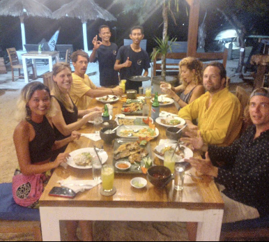 A group of people are sitting around a table eating food