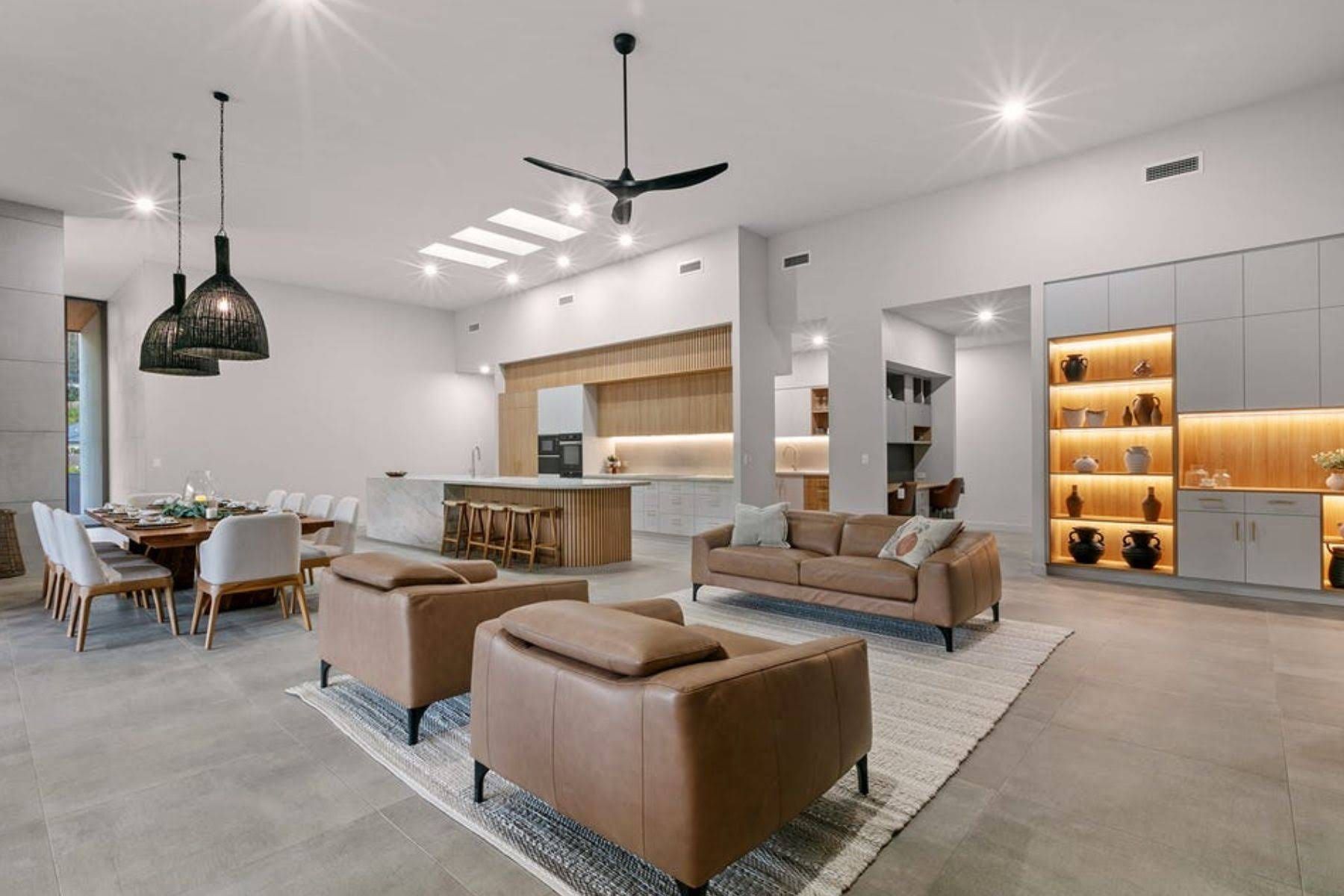 A Spacious, Modern Living Area With Leather Sofas and Built-in Shelving — OHMY Electrical Contractors in Carina, QLD