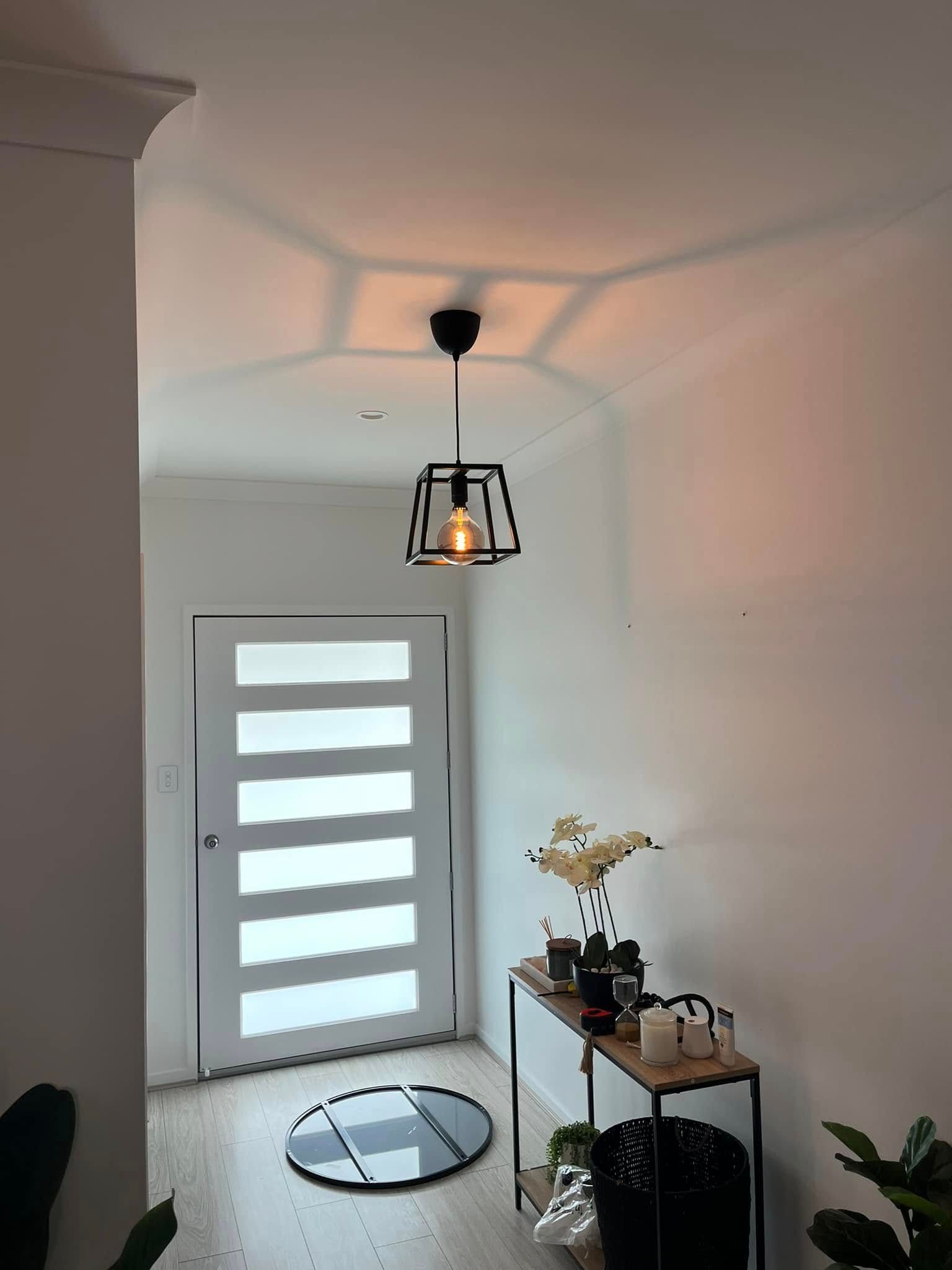 A Modern Entryway With a Dark Metal Cage Pendant Light — OHMY Electrical Contractors in Coorparoo, QLD