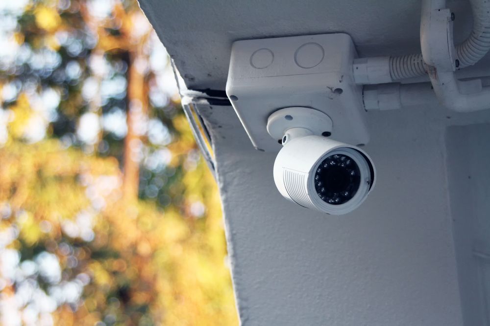 A White Security Camera Mounted on the Underside of an Eave — OHMY Electrical Contractors in Carina, QLD