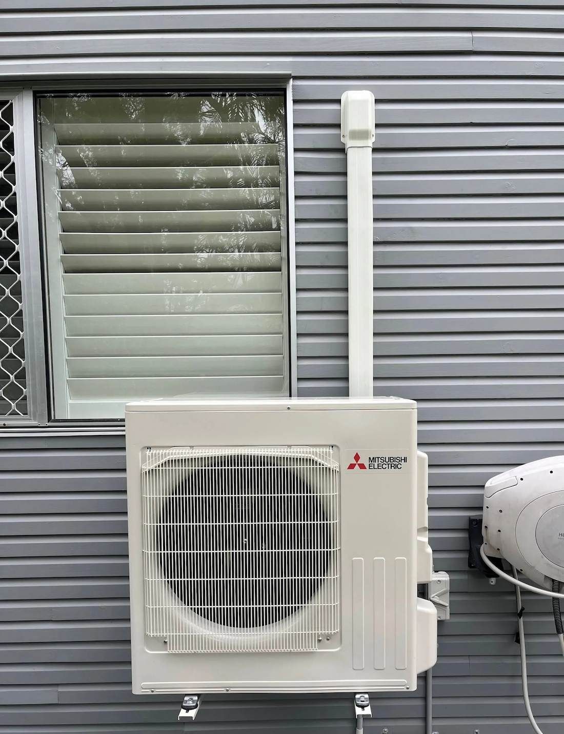 Air Conditioning In Carindale Outdoor Unit Mounted On Home Wall