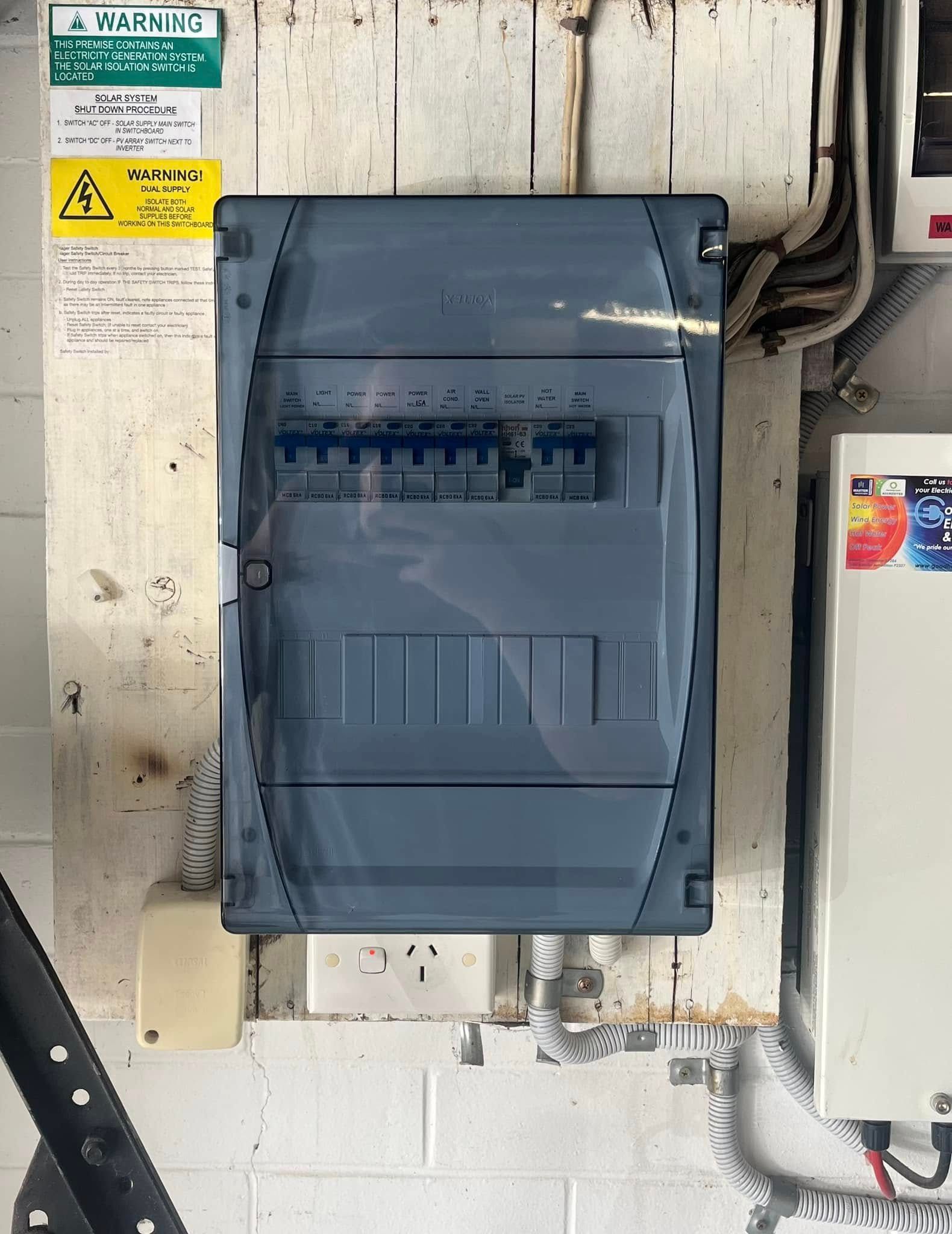 A Grey Electrical Distribution Board With Circuit Breakers — OHMY Electrical Contractors in Carina, QLD
