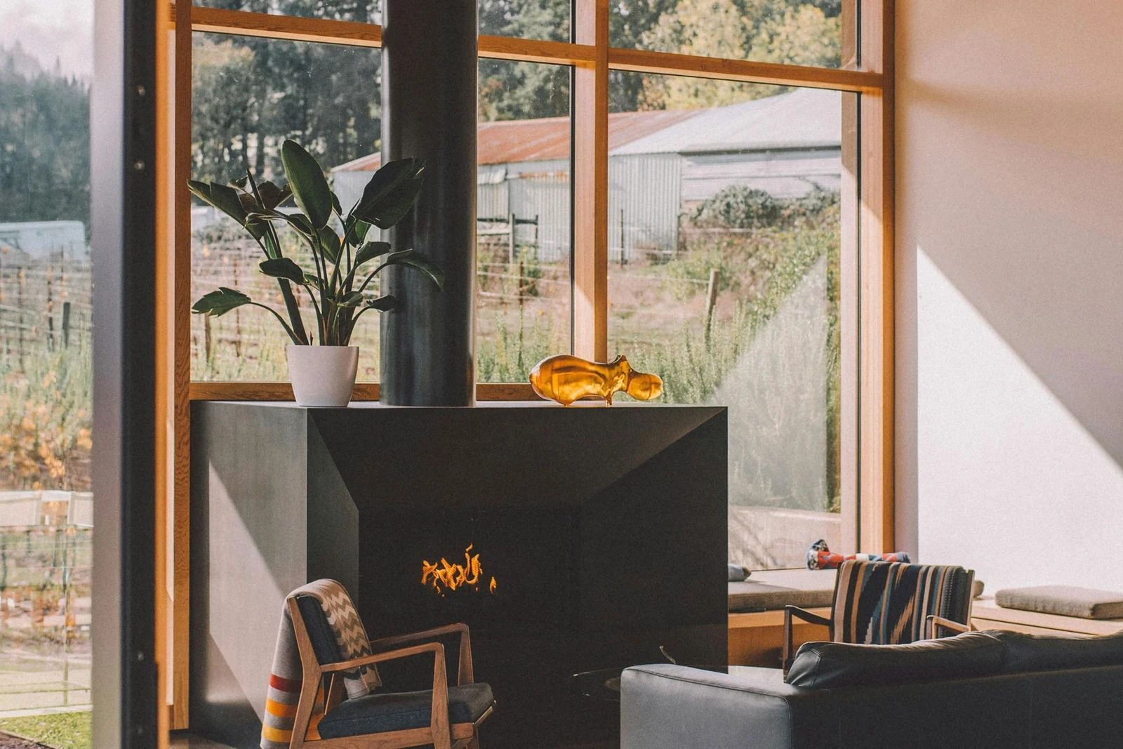 Modern Living Room With a Large Black Fireplace and Floor-to-ceiling Windows — OHMY Electrical Contractors in Carina, QLD