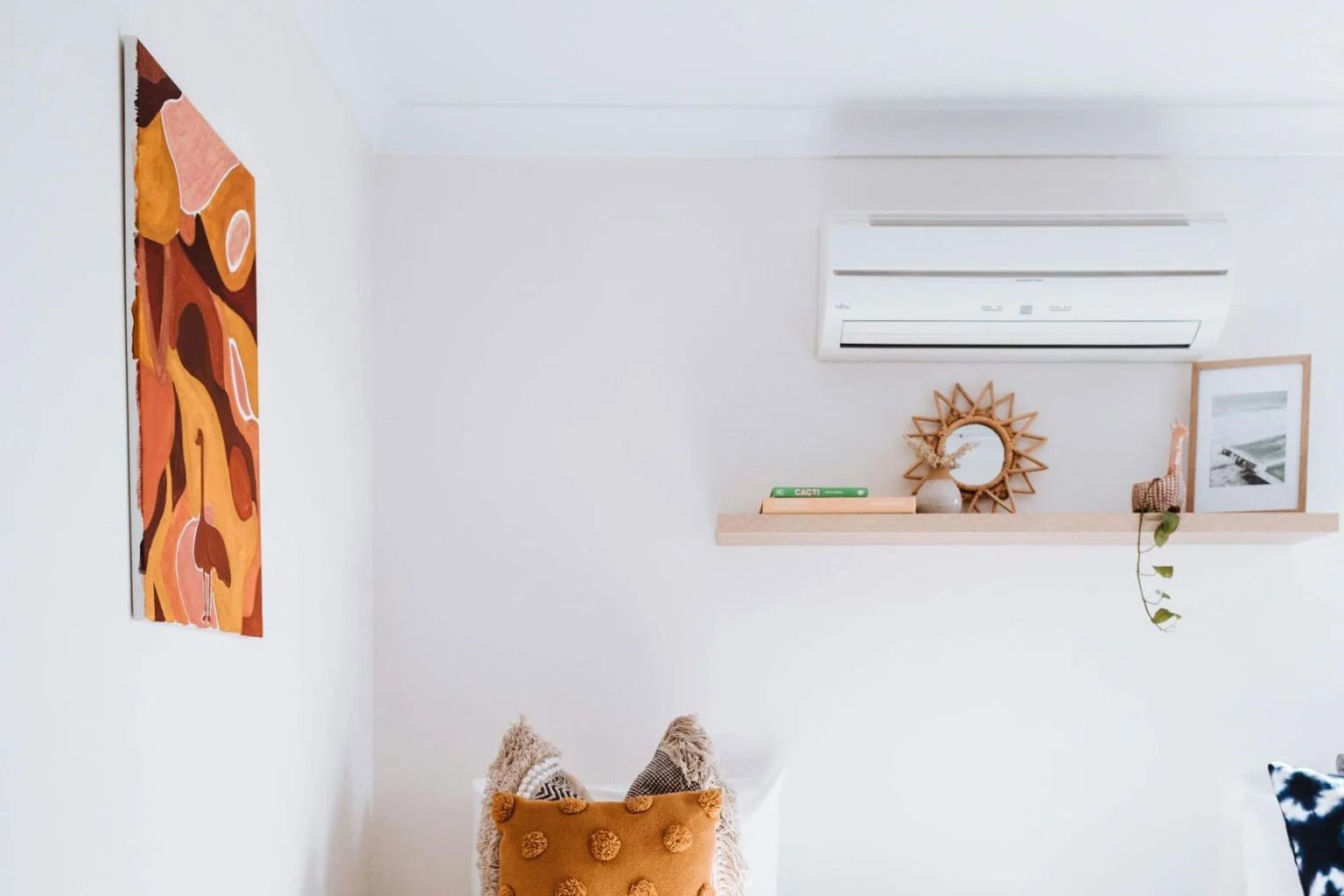 A Neutral Room With a Warm-toned Abstract Painting — OHMY Electrical Contractors in Carina, QLD