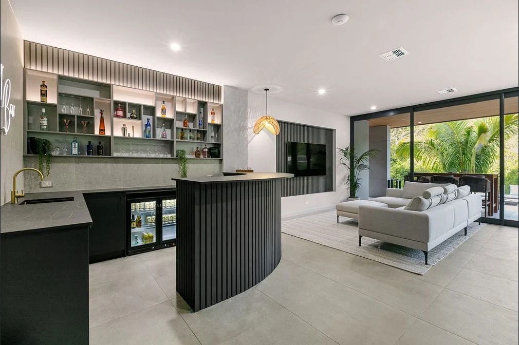 Modern Living Space With a Curved Dark Bar — OHMY Electrical Contractors in Carina, QLD
