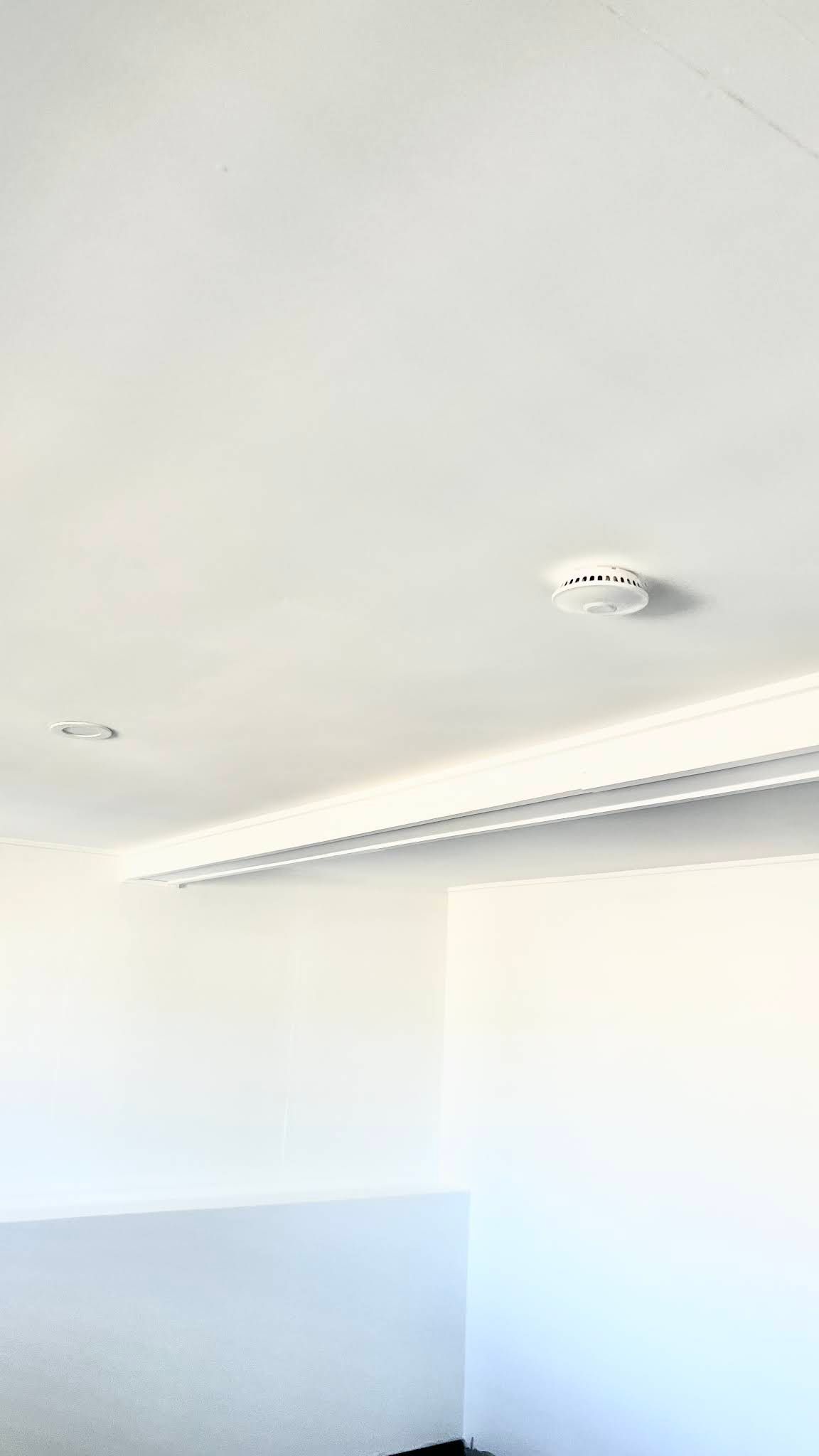 A White Ceiling Featuring a Circular Smoke Detector — OHMY Electrical Contractors in Carina, QLD