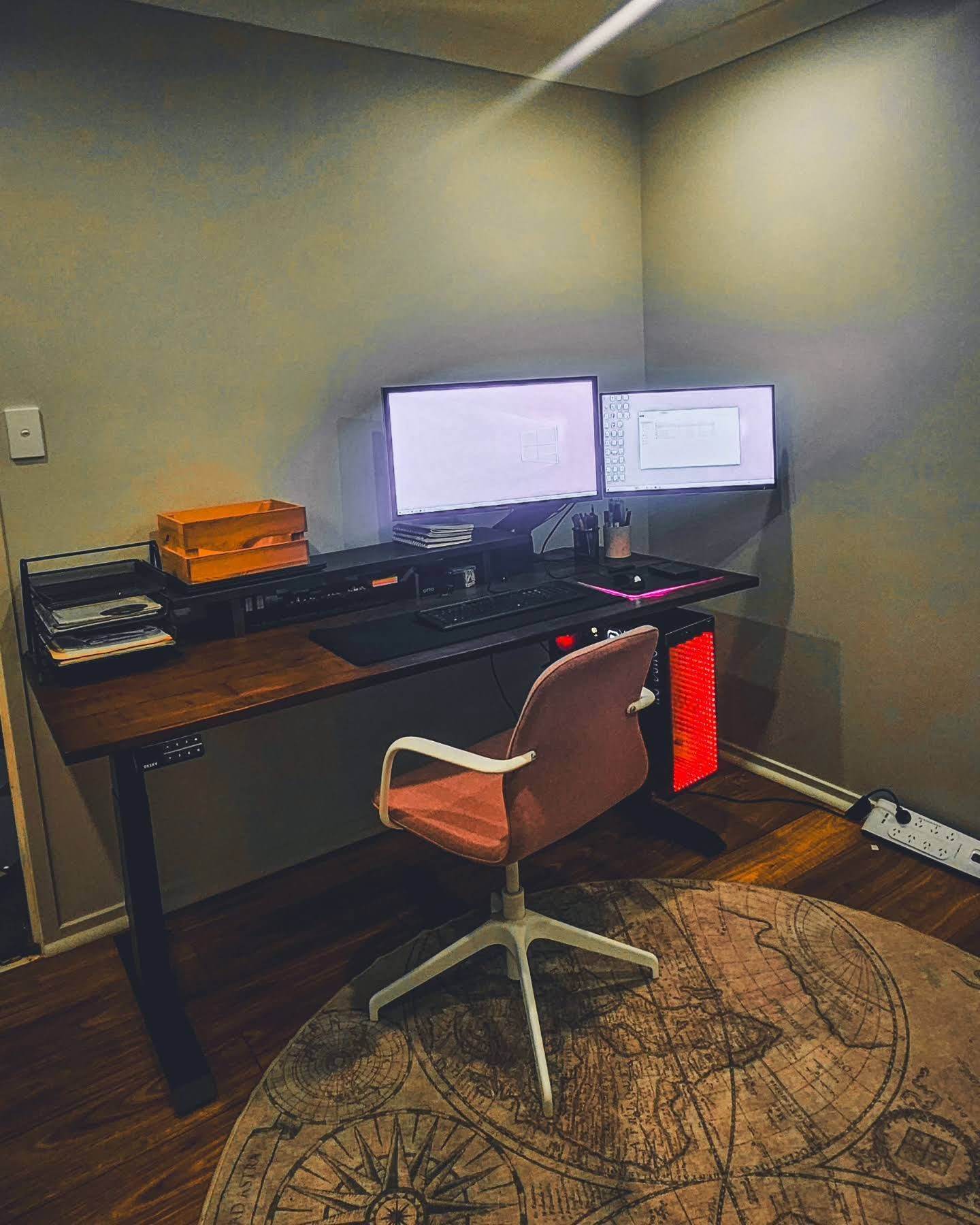 A Home Office Setup With a Desk, Dual Monitors, Computer Tower, and Pink Chair — OHMY Electrical Contractors in Carina, QLD