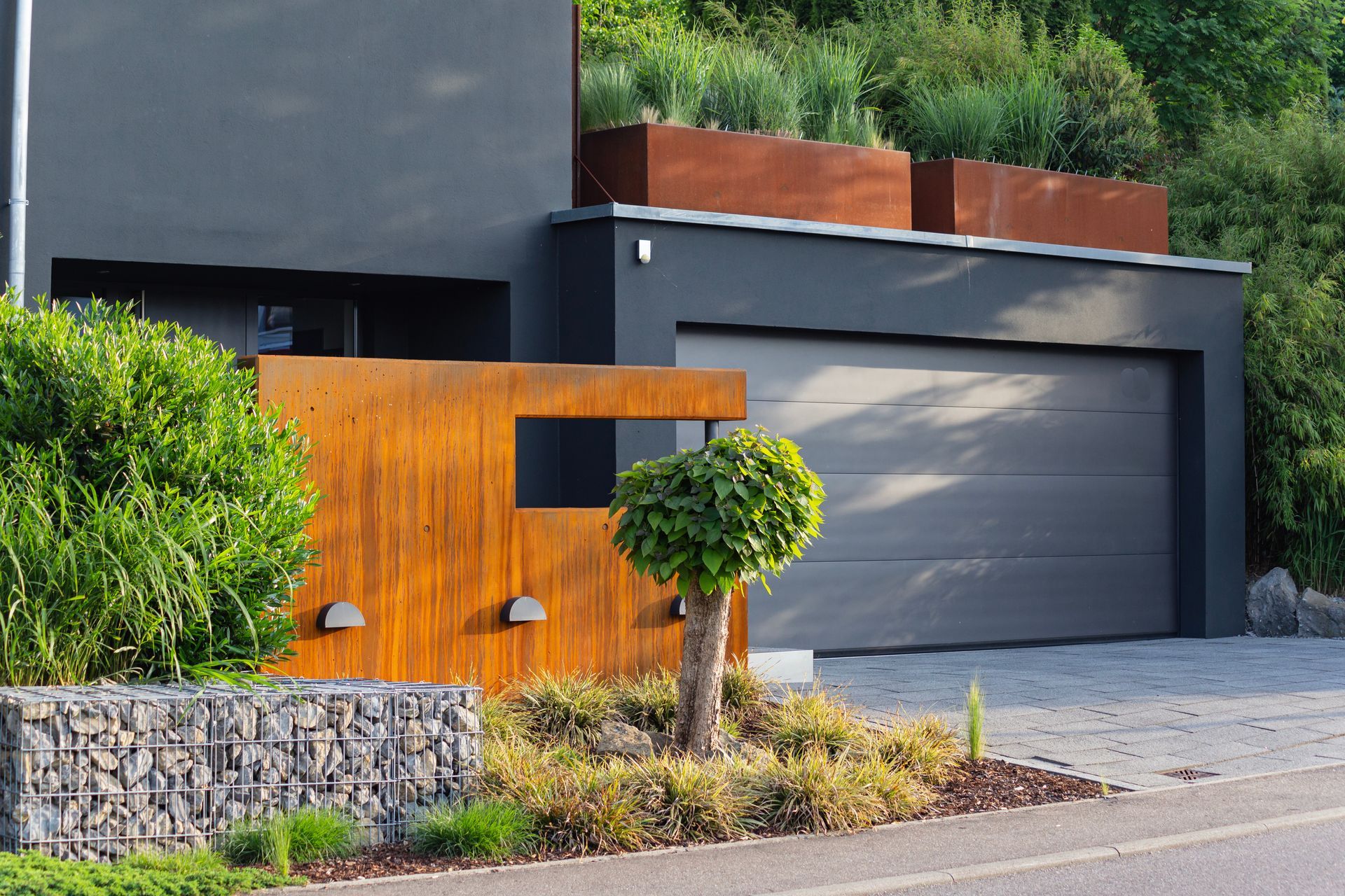 Modern house exterior with gray garage door, orange accent wall, and landscaped front yard