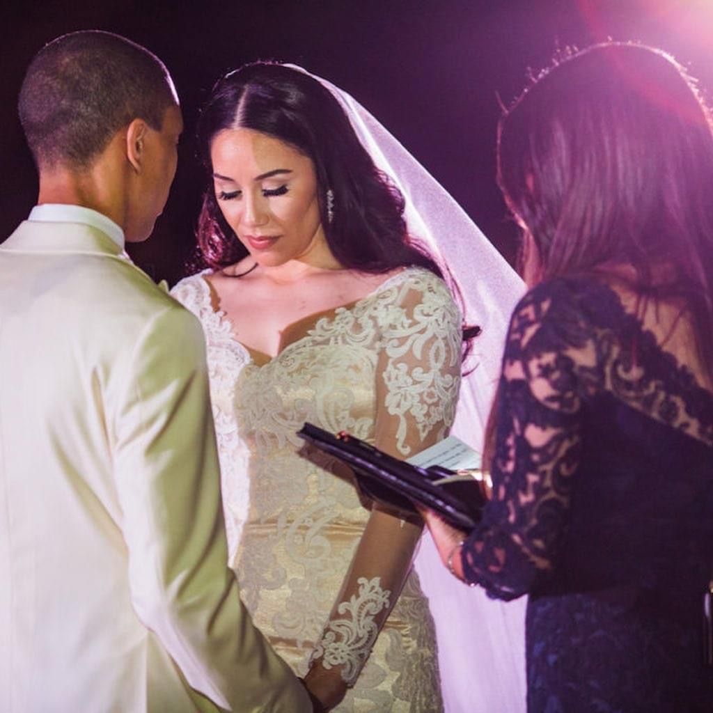Wedding officiant with married couple