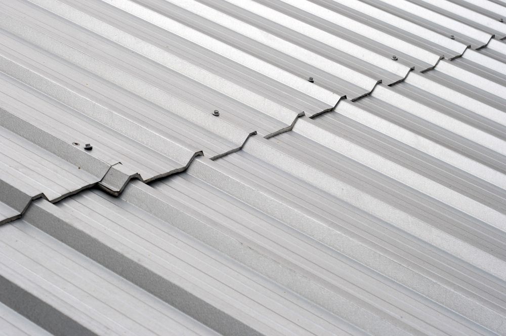 A Close Up of a Metal Roof With Cracks in It — Apex Roofing Group in Brunswick Heads, NSW