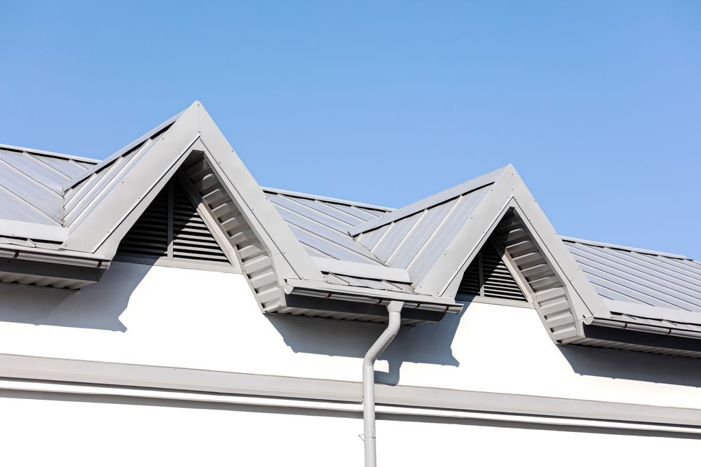 The Roof of a Building With a Gutter and a Blue Sky in the Background — Apex Roofing Group in Mullumbimby, NSW
