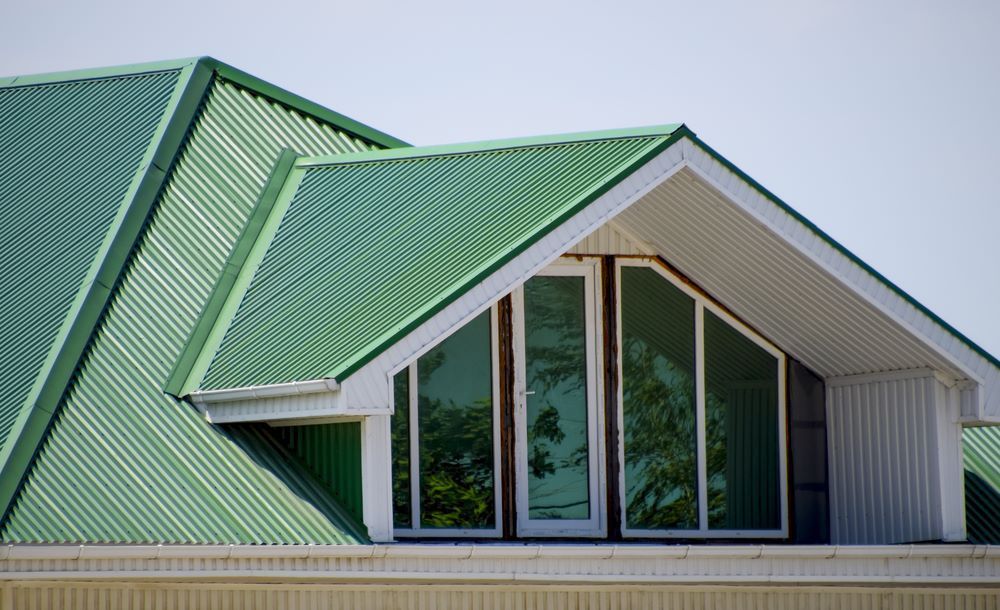 The Roof of A House with A Green Roof and A Window — Apex Roofing Group in Wooli, NSW