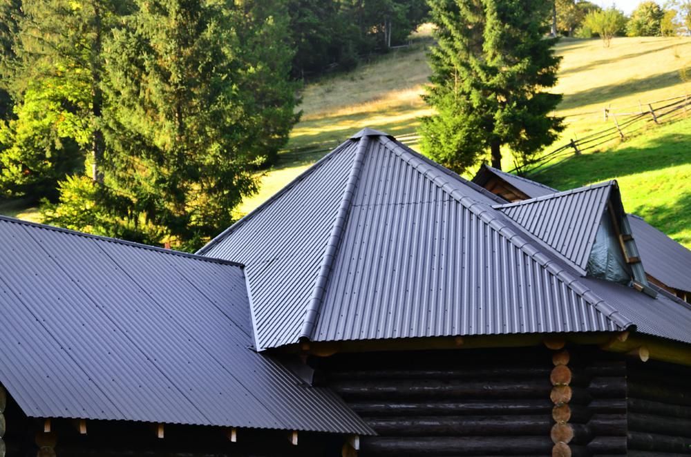 A Log Cabin with A Corrugated Metal Roof — Apex Roofing Group in Grafton, NSW