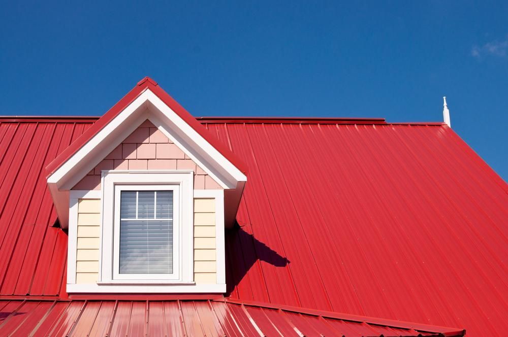 A Red Roof with A Window on Top of It — Apex Roofing Group in Maclean, NSW