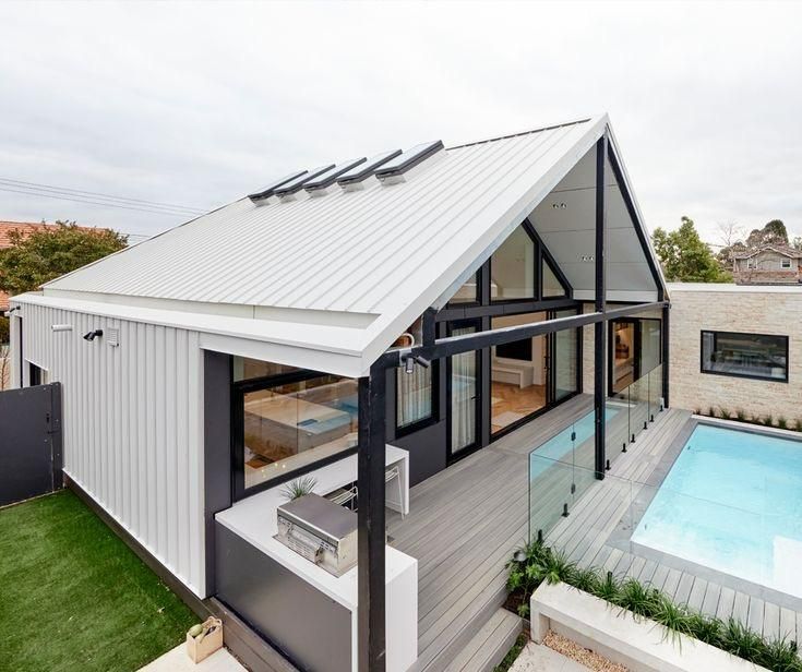 A White House with A Swimming Pool in The Backyard — Apex Roofing Group in Wooli, NSW