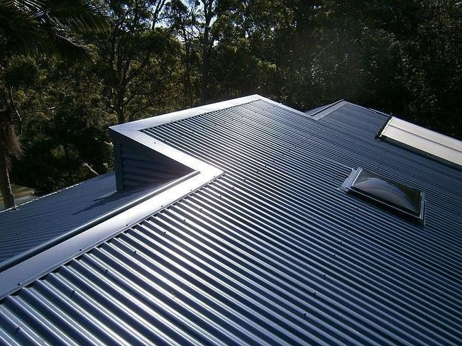 A Roof with A Skylight and Trees in The Background — Apex Roofing Group in Bangalow, NSW