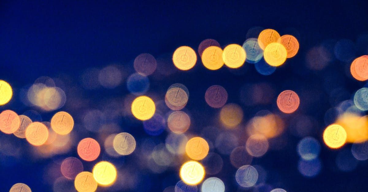 Blurred city lights at night with warm yellow and orange bokeh on a blue background