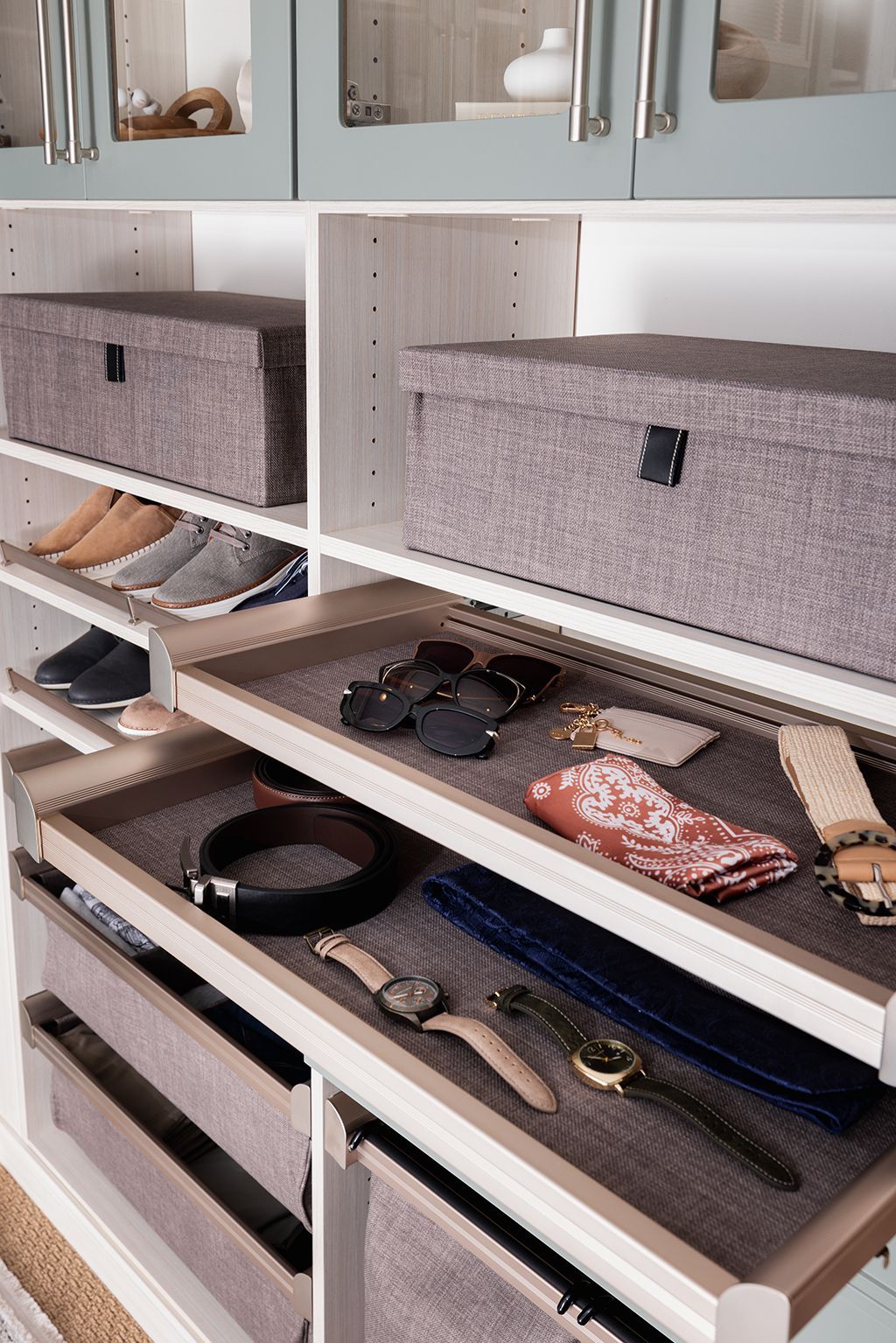 Open dresser drawers with belts, watches, and ties neatly organized inside