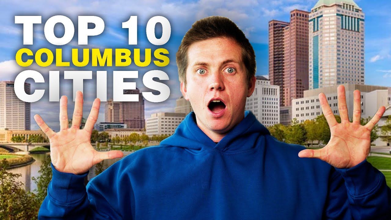 A man in a blue hoodie is standing in front of a city skyline.
