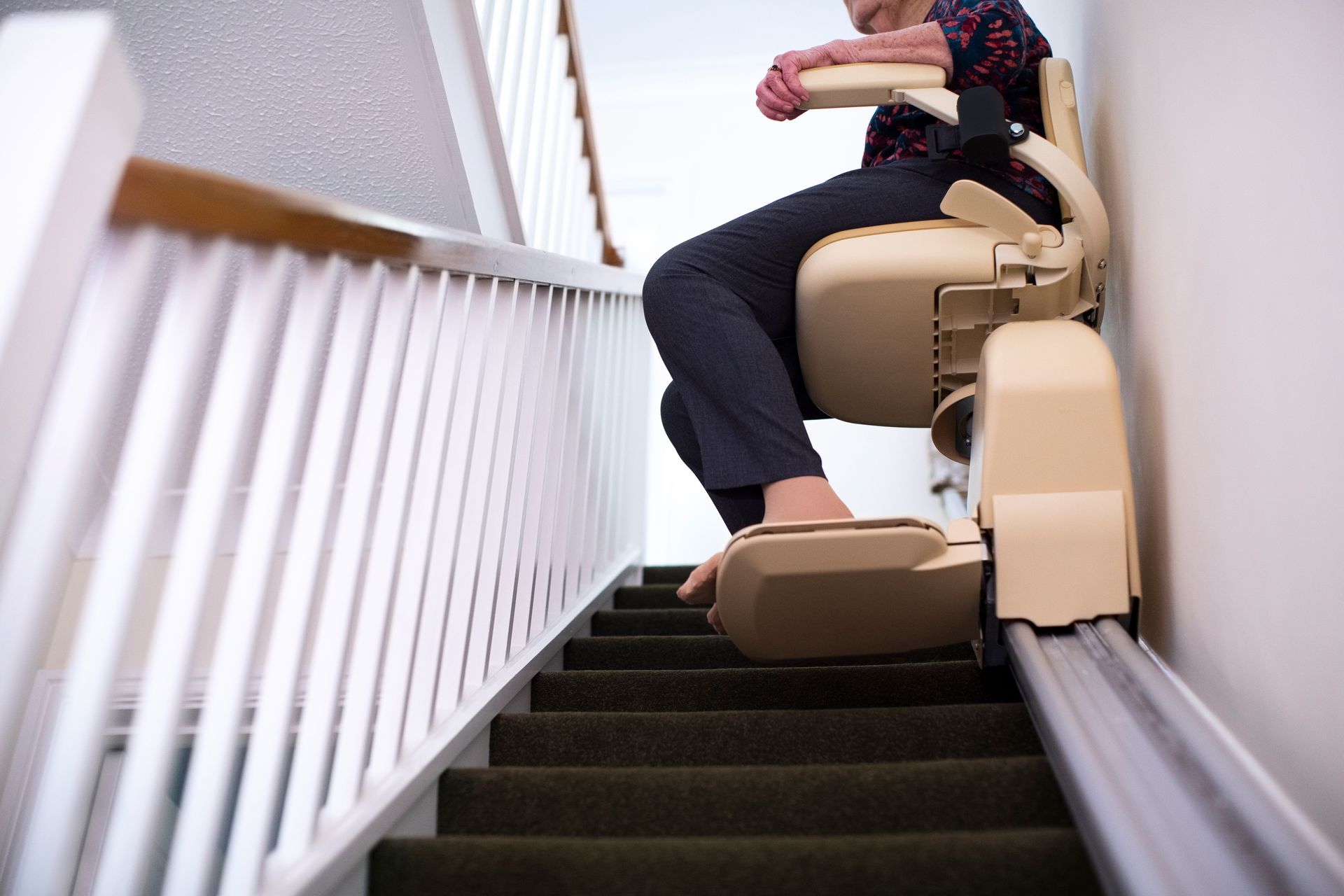 A woman sitting on a stair lift. A woman sitting on a stair lift.
