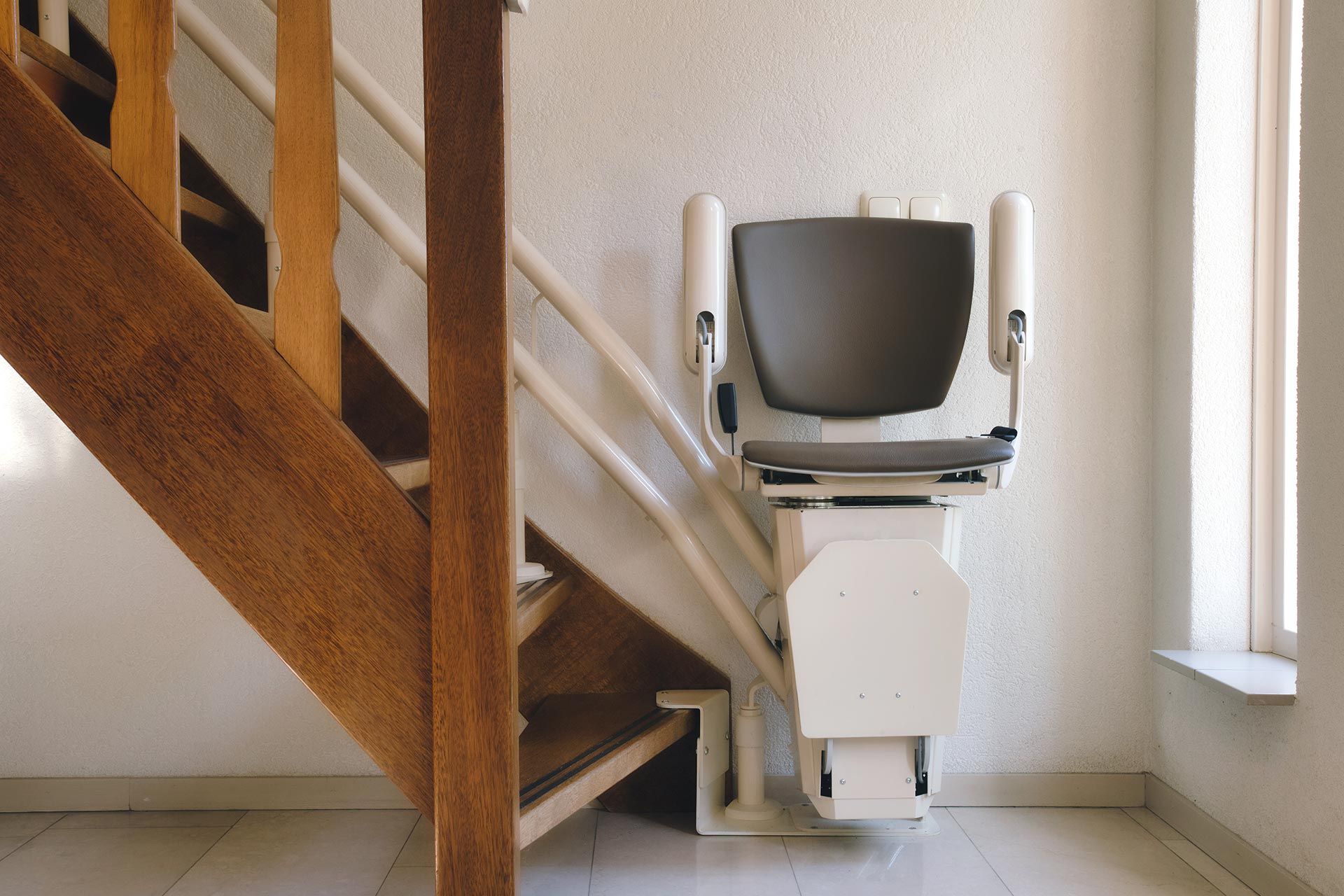 Stairlift chair installed on an indoor staircase, providing safe and accessible mobility support. Stairlift chair installed on an indoor staircase, providing safe and accessible mobility support.