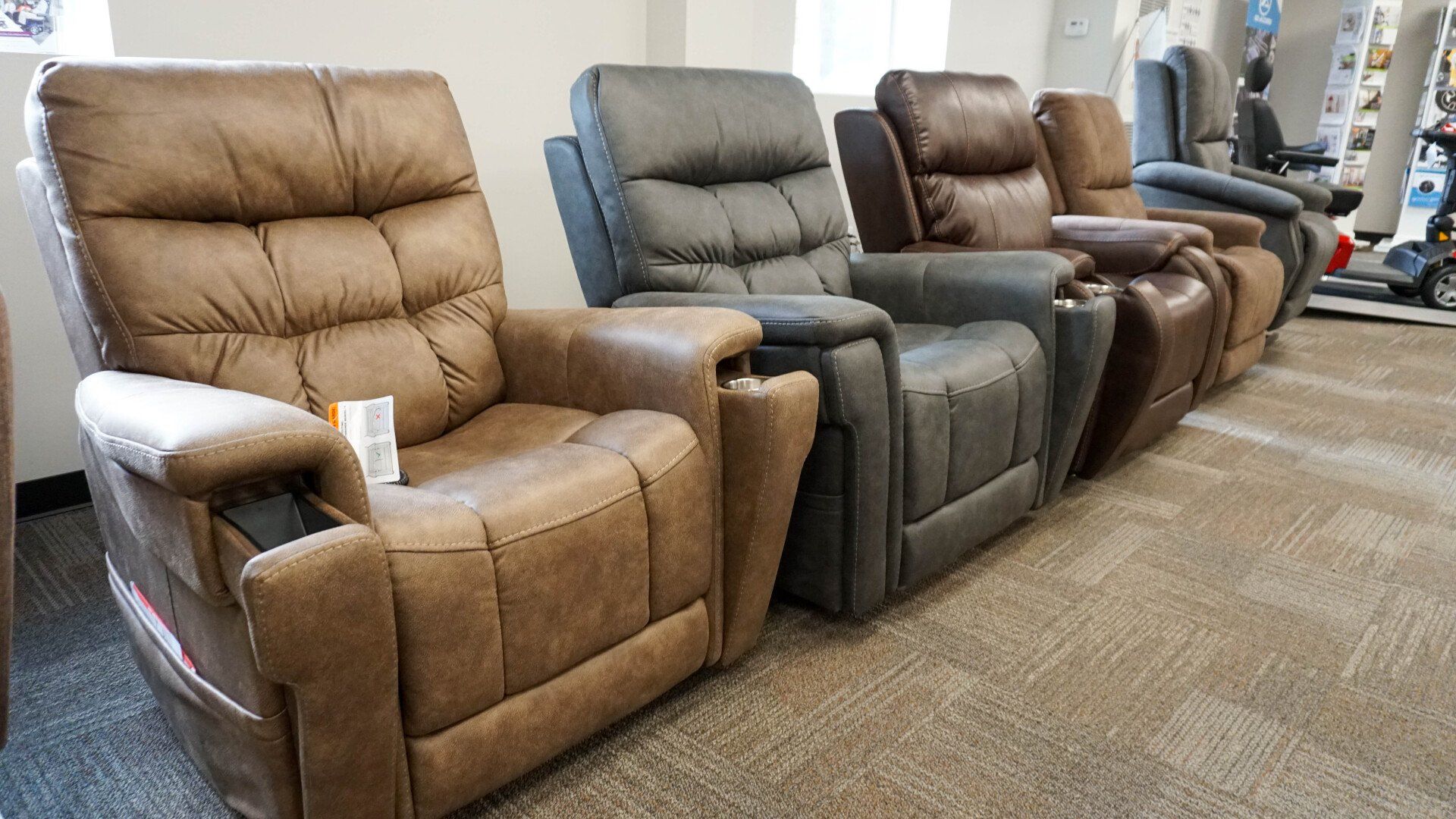 A row of recliner chairs are lined up in a room.