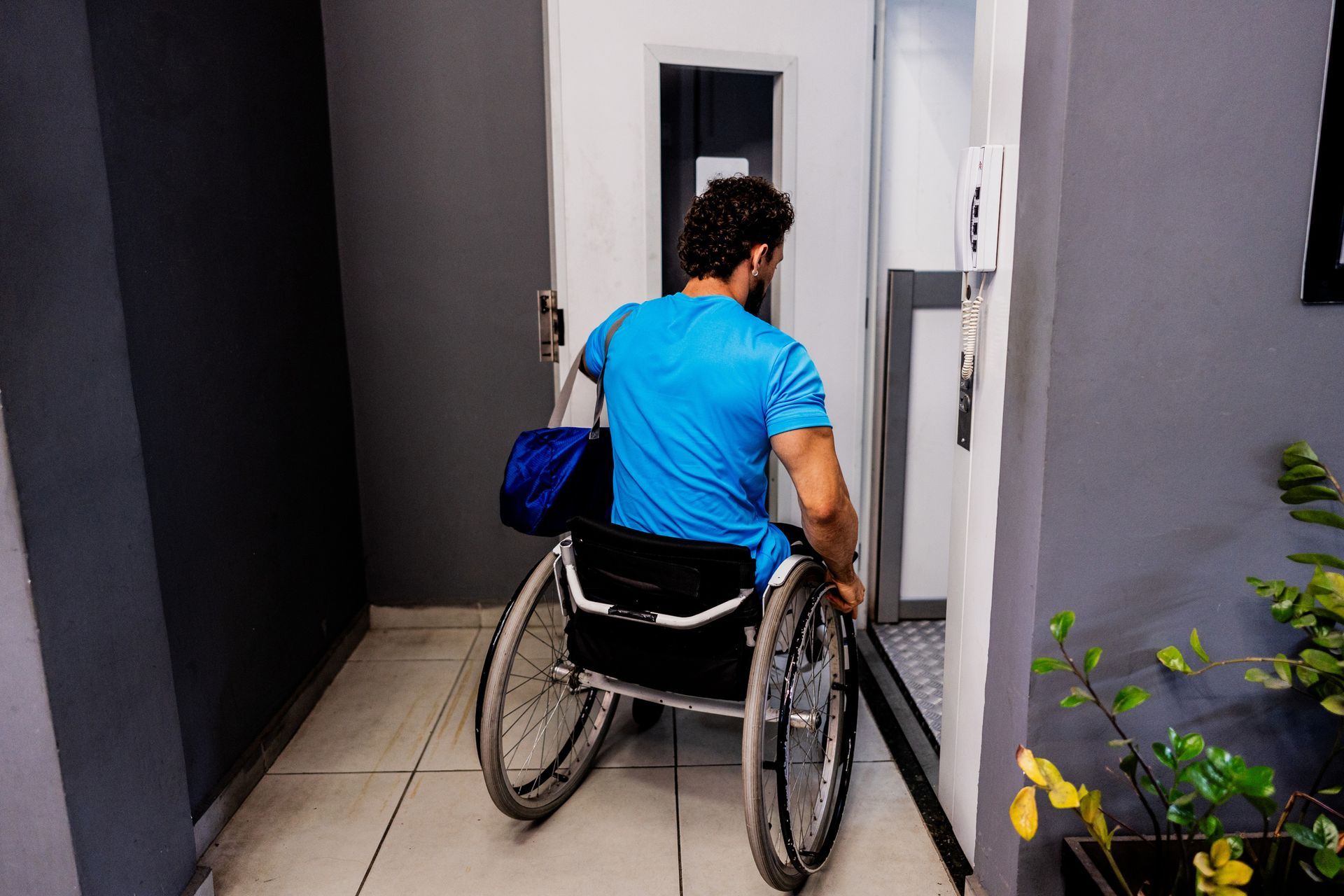 Man in wheelchair entering on elevator.