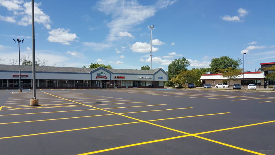 Front Of Store With Newly Sealcoat Parking Lot With Few Cars - Clio, MI - Chippewa Asphalt Paving Front Of Store With Newly Sealcoat Parking Lot With Few Cars - Clio, MI - Chippewa Asphalt Paving