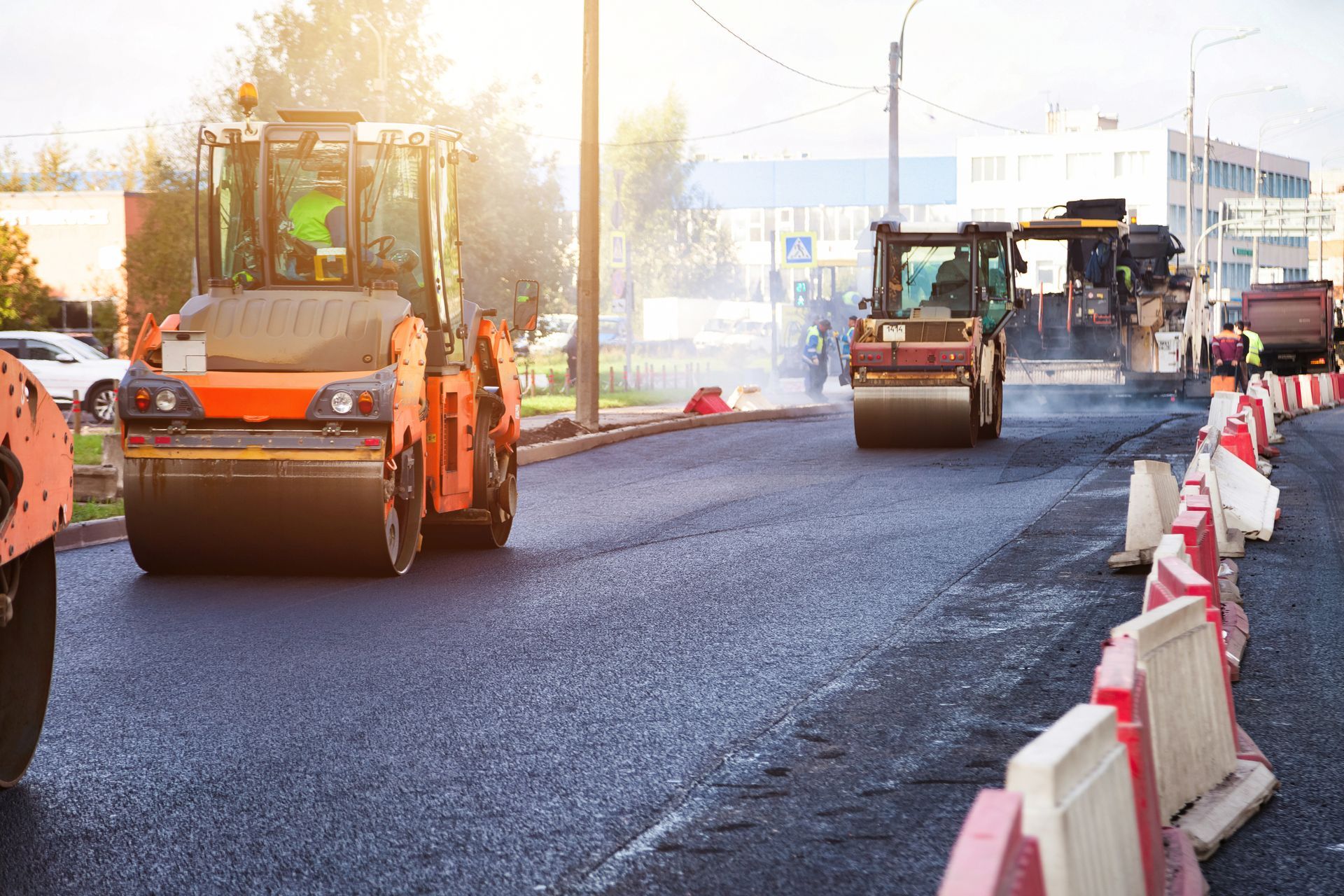 Road construction crew resurfacing a street with asphalt paving equipment