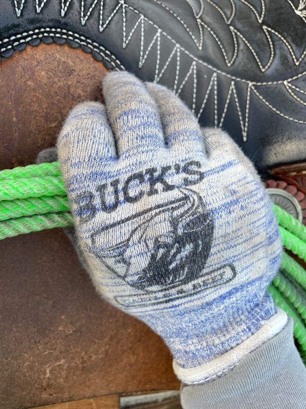Blue-and-white knit work glove on a dark textured surface