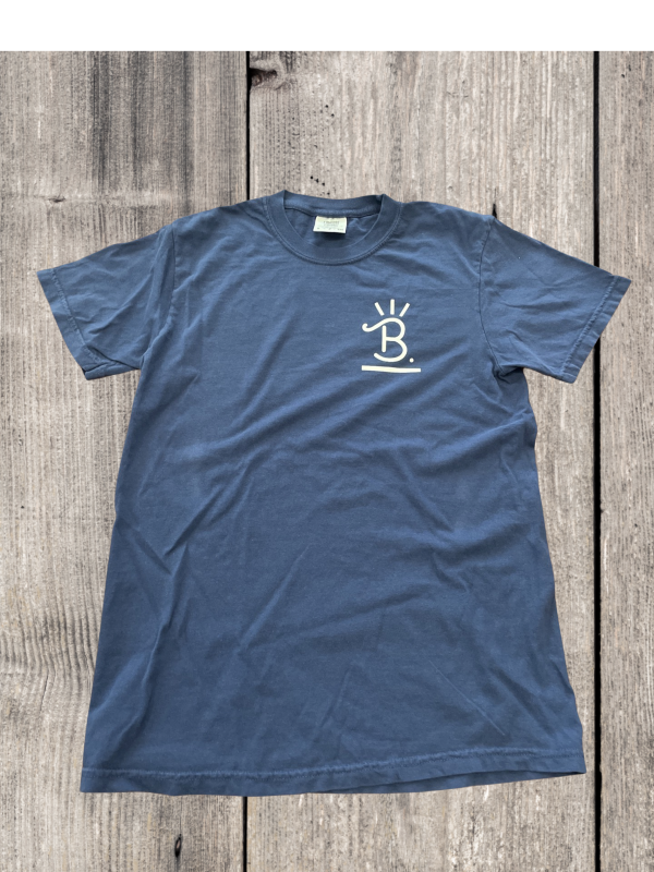 Blue Buck’s Cattle & Beef T-shirt laid flat on a wood background
