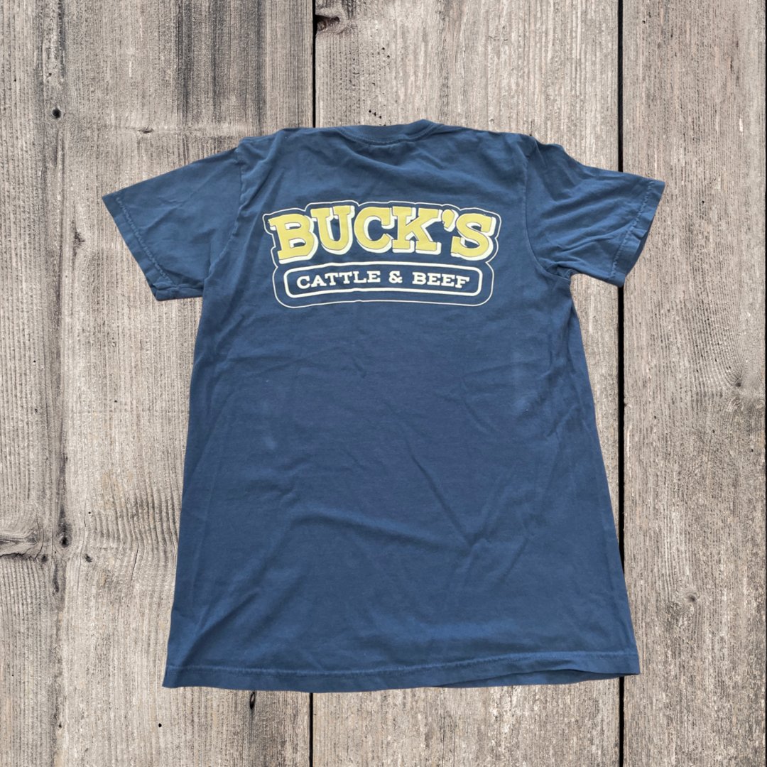 Blue Buck’s Cattle & Beef T-shirt laid flat on a wood background
