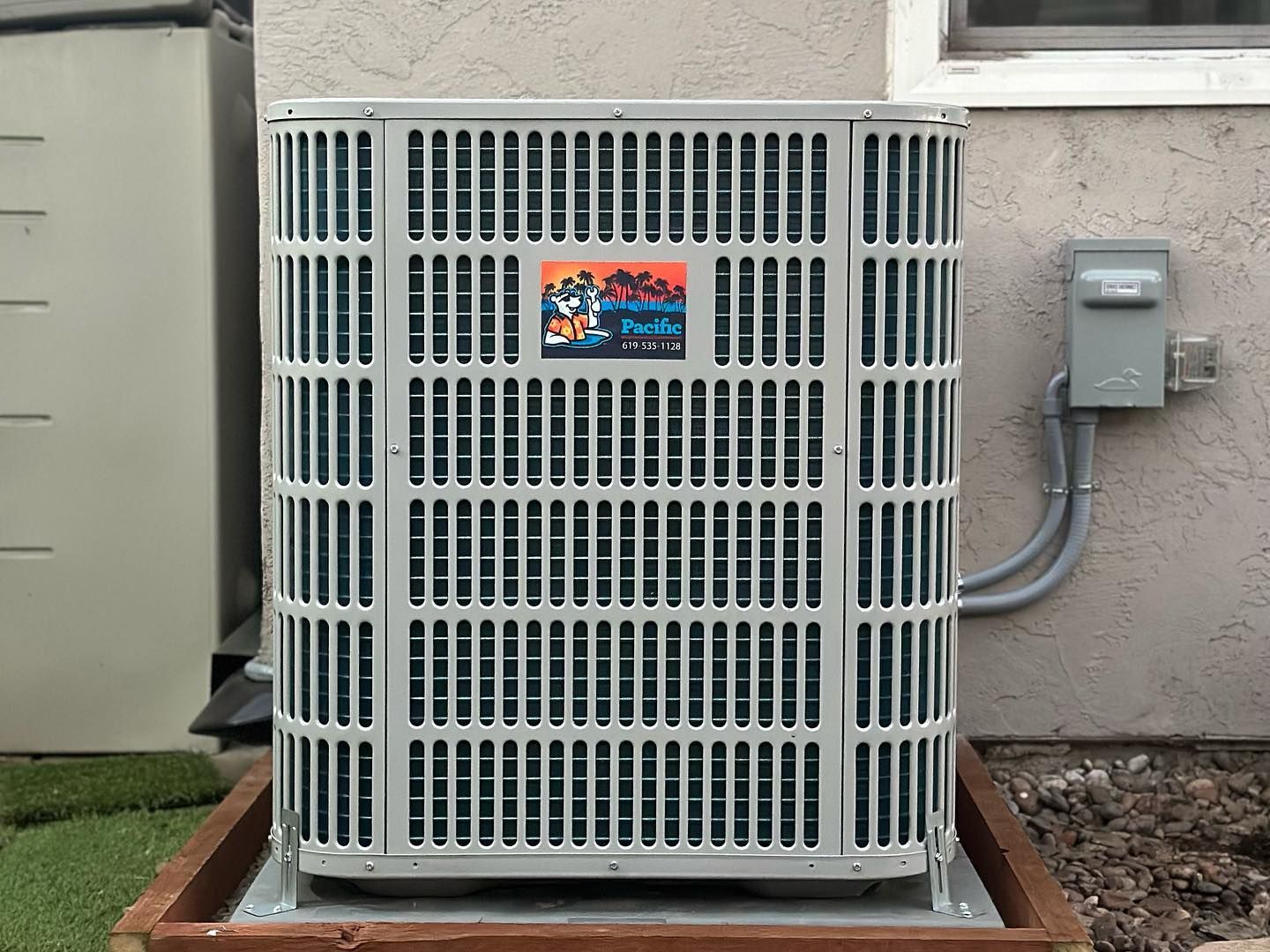 Four large rooftop HVAC units with visible fans and connecting pipes on a building roof