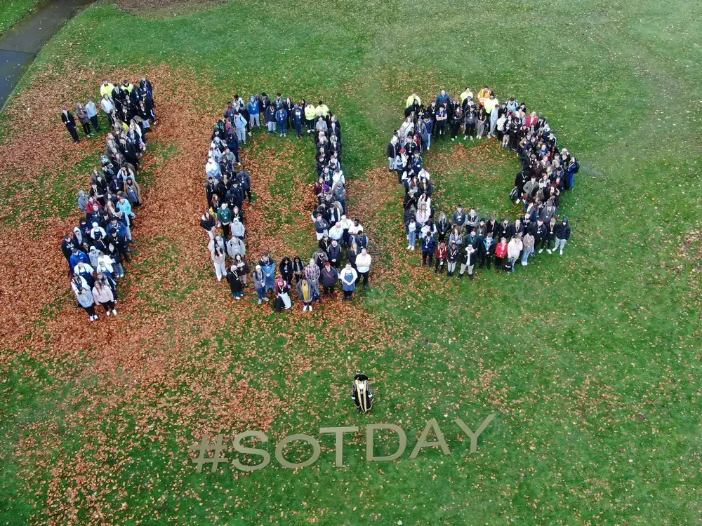 Large group of people forming the number 