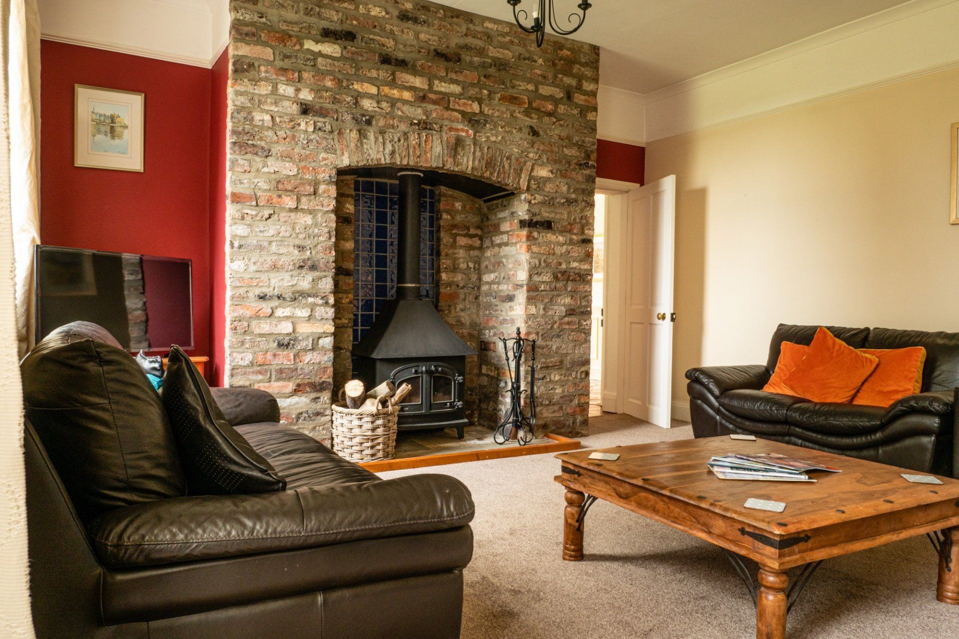 A living room with two couches , a coffee table and a fireplace.