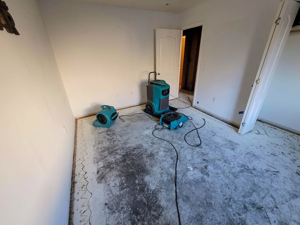 air movers and a dehumidifier used during water damage restoration in an apartment unit
