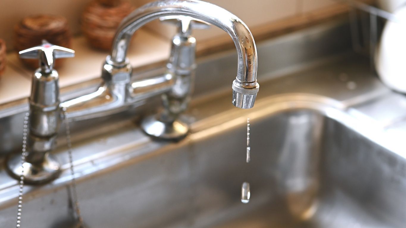 leaky faucet causing water damage in a home