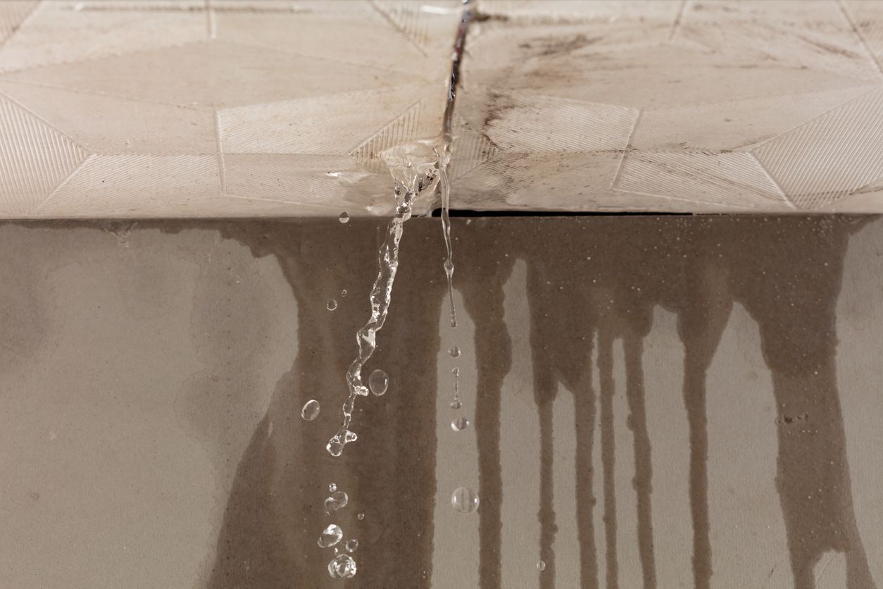 water dripping from a ceiling - signs of water damage